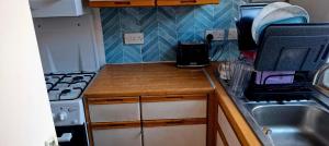 a small kitchen with a sink and a stove at Stratford Terrace in Beeston