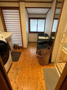 a small room with a door and a wooden floor at かんぬしの宿 in Yamaguchi