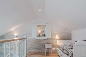 a bedroom with a bed and a mirror on the wall at Preilos Perliukas in Preila