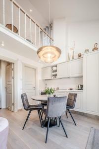 a dining room with a table and chairs at Preilos Perliukas in Preila