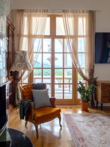 a living room with a couch and a large window at Santa Barbara House in Ratiševina