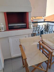two chairs and a table on a balcony at Dinas house ofrinio in Ofrínion +7 photos