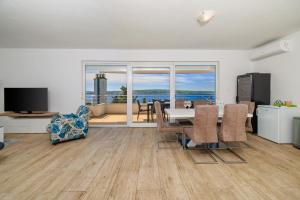 a living room with a dining table and a view of the ocean at Melanie in Crikvenica