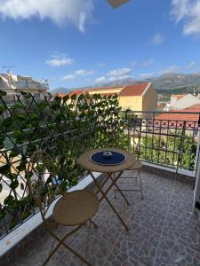 a patio with a table and chairs on a balcony at Rocky Stays - Argostoli Central Studio in Argostoli