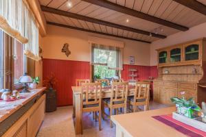 a kitchen with a wooden table and chairs at Pension Haus Brückner in Wildemann
