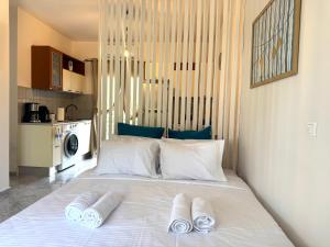 a bedroom with a bed with two towels on it at Rocky Stays - Argostoli Central Studio in Argostoli