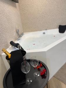 a bath tub with two glasses of wine and a bottle of champagne at El Rincón de Mateo in Combarro +22 photos