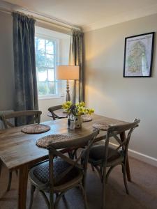 a dining room with a wooden table and chairs at Halton Red House Farm in Stagshaw Bank