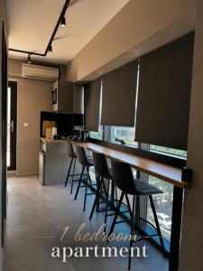 a kitchen with a long table and chairs in a kitchen at VARTAN LUX apt in Alexandroupoli