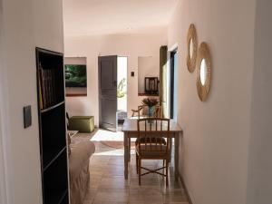 a dining room with a table and a chair at Lombard Manor in Pretoria