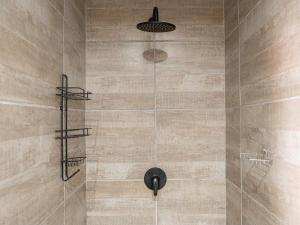 a shower with a black shower head in a bathroom at Lombard Manor in Pretoria +141 photos