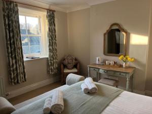 a bedroom with a bed and a desk and a window at Halton Red House Farm in Stagshaw Bank