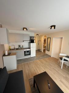 an open living room and kitchen with white appliances at S22 Living in Weingarten (Karlsruhe)