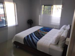 a bedroom with a large bed with a window at BOU's Accomodation in Nadi
