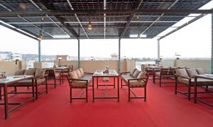 a dining room with tables and chairs on a roof at Anandam Hotel in Jaipur
