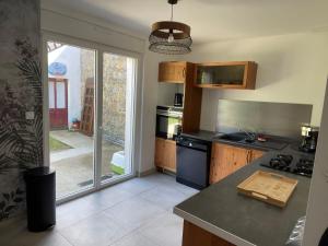 a kitchen with a sink and a stove top oven at Maison de campagne in Le Wast