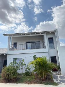 a white house with a balcony on top of it at שחף על הכנרת in HaOn