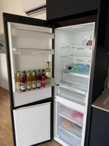 an open refrigerator filled with drinks and alcohol at שחף על הכנרת in HaOn