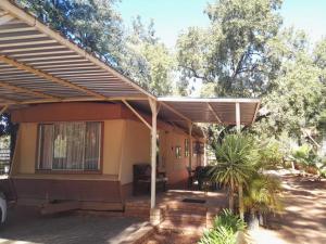 awning over a patio of a house at Kettle Guest Lodge Rustenburg in Rustenburg