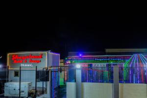 a building with a neon sign in front of it at Shugaland hotel and lounge in Ibadan