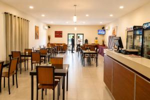 a dining room with tables and chairs in a restaurant at Viana Hotel in Luanda