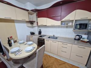 a kitchen with a table and chairs and a sink at Velvet Nest in Kumanovo +21 photos