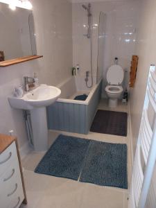 a bathroom with a tub and a sink and a toilet at B&B Buddleja in Saint-Hilaire-les-Places