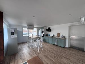 a kitchen with a table and chairs in a room at Le Cabieu in Ouistreham