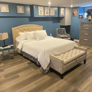 a bedroom with a large bed and a chair at Maxis-place in Jersey City +56 photos