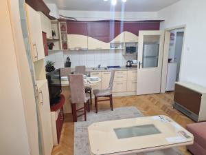 a kitchen with a table and a dining room at Velvet Nest in Kumanovo