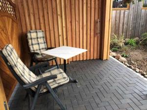 two chairs and a table on a patio at Ferienwohnung Maltzahn & Beese in Jabel