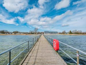 a wooden pier on a body of water at Ferienwohnung Kranich - Dranske in Dranske