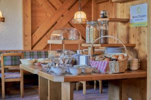 a table with bread and baskets of food on it at Pension Sonnwend - inklusive Gästekarte in Fieberbrunn +21 photos