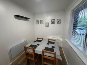 a dining room with a table and chairs and a window at Spacious 1bed Apartment Close To Town in Ifield