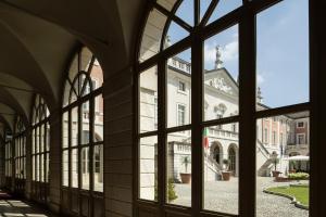 a view of a building through a window at Villa Fenaroli Palace Hotel in Rezzato
