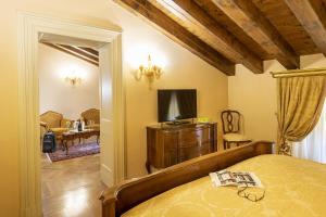 a bedroom with a bed and a chair in a room at Villa Fenaroli Palace Hotel in Rezzato +76 photos