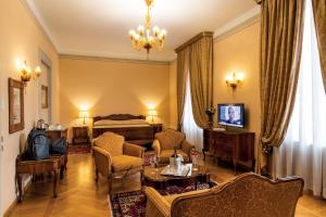 a bedroom with a bed and a living room at Villa Fenaroli Palace Hotel in Rezzato