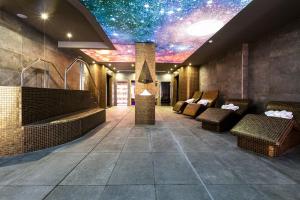 a lobby with chairs and a star ceiling at Hotel & Spa Ciudad de Binéfar in Binéfar