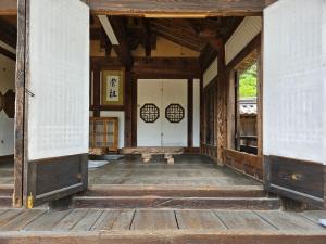 an entrance to a japanese house with a wooden floor at Tohyang Traditional House in Bonghwa