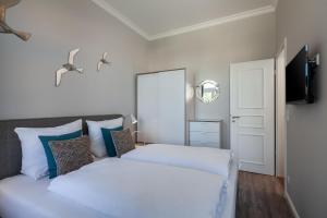 a bedroom with two beds and a television at App Flamingo in Kühlungsborn