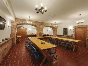 a large room with wooden tables and chairs at Szilva Ház in Szilvásvárad
