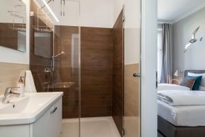 a bathroom with a shower and a sink at App Flamingo in Kühlungsborn