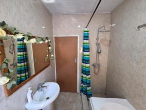 a bathroom with a sink and a shower at Mel's Apartment in Ndola +18 photos