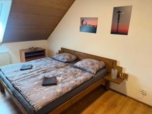 a bedroom with a bed with two pillows on it at Rašovka - Bílý dům in Šimonovice +94 photos