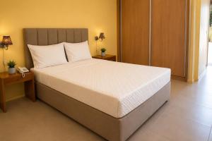 a bedroom with a large bed with a phone on a table at Viana Hotel in Luanda