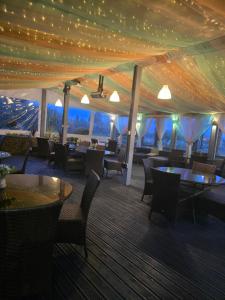 a tent restaurant with tables and chairs and a view at The Falcon At Hatton in Hatton