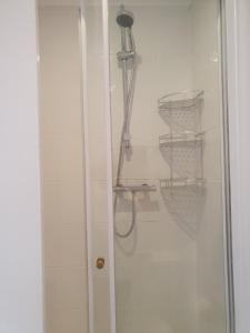 a shower stall with a glass door with a shower at Smugglers Rest in Newquay +42 photos