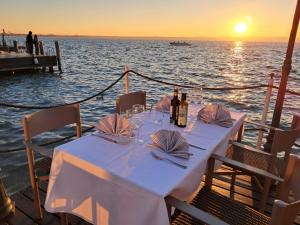 a table with wine bottles and glasses on a boat at Hotel Pace in Sirmione +36 photos