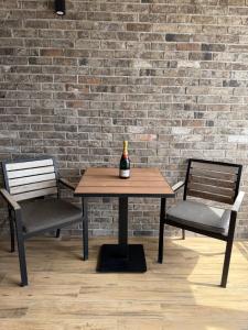 a bottle of wine sitting on a table with two chairs at No Stress in Borča