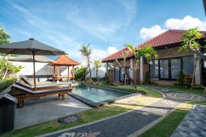 a house with a pool and a bench and an umbrella at Ulu Apsura Villas in Uluwatu